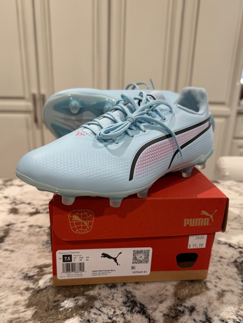 Puma Womans Light Blue Soccer Cleats with Black Stripe